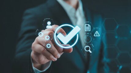 Ensuring Quality: An individual hand, poised with precision, interacts with an illuminated digital check mark symbol, signifying endorsement and assurance, set against a dark background.