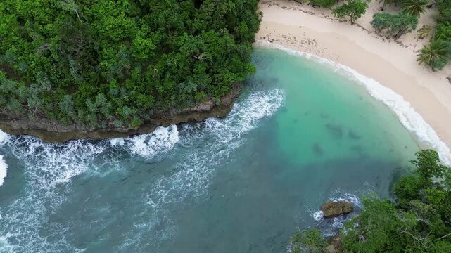 Top Down Drone View of Ocean Waves Crashing on Rocky Coast, Ngliyep Beach Indonesia