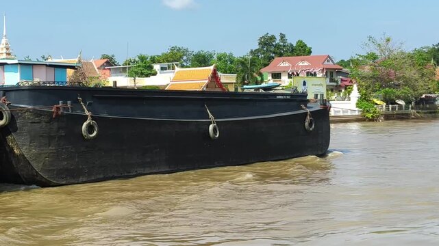 Close up Iam Chun Boat, Chinese Cargo Boat, Boats on a calm river near a coastal city on a sunny summer day