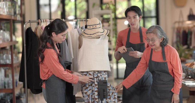 A mother, son, and daughter from a family business host a live stream, showcasing ceramic products on camera while managing orders and engagement for e commerce sales.
