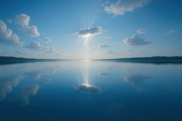 Calm lake reflecting sky and clouds at sunrise with peaceful natural scenery