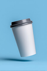 Obraz premium Floating White To-Go Coffee Cup With Grey Lid On Bright Blue Background