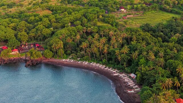 Aerial drone view of Tulamben bay with traditional jukung fishing boats on the beach
