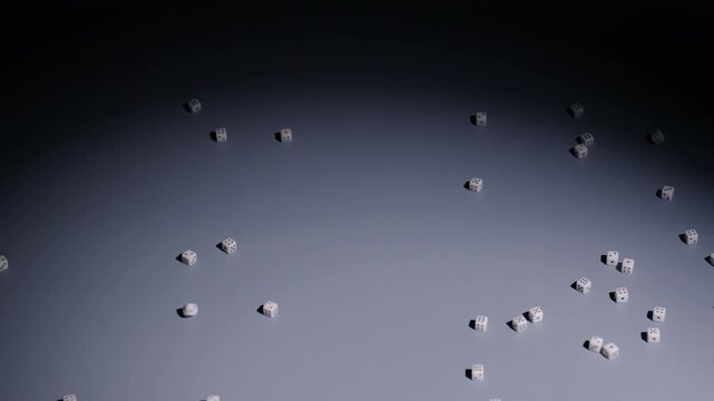 Slow-motion wide shot as a bunch of tiny dice fall into middle of screen and bounce and roll around.