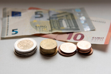 Euro coins with five and ten Euro bills on table