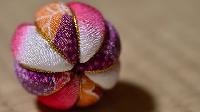 Traditional Japanese Temari Ball Close Up on Tatami Mat Left