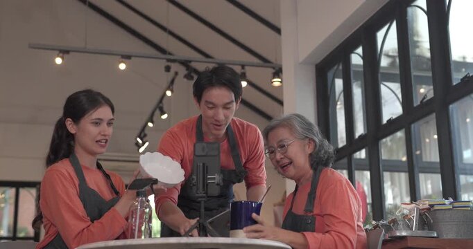A mother, son, and daughter from a family business host a live stream, showcasing ceramic products on camera while managing orders and engagement for e commerce sales.
