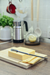 Bamboo cutting board with a built-in cheese cutting device