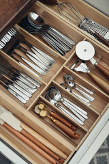 Bamboo organizer with cutlery in kitchen drawer
