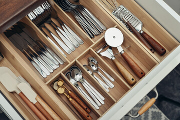 Bamboo organizer with cutlery in kitchen drawer