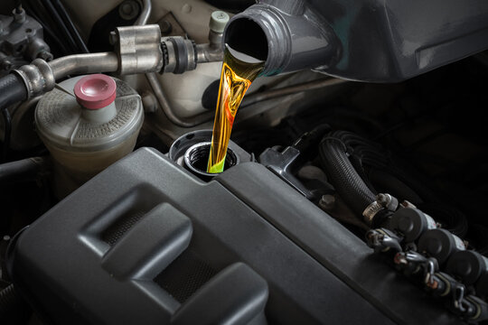 Fototapeta Refueling and pouring oil quality into the engine motor car Transmission and Maintenance Gear .Energy fuel concept