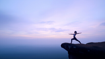 Woman practicing yoga on cliff at sunset, ideal for wellness or travel themed designs requiring peaceful, inspiring imagery of nature.