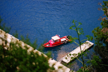 Red Search And Rescue Speedboat Docked Near a White Pier on Deep Blue Water