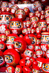 DARUMA dollss with Japaness word, which means victory, in Kachioji Temple Osaka Japan