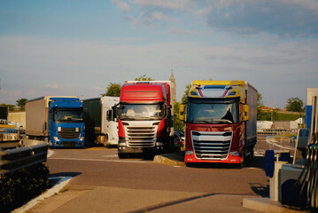 Multi-Colored Semi-Trucks Parked at a Commercial Fueling Station Paid Parking Place