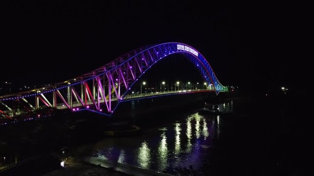 Kutai Kartanegara Bridge, East Kalimantan Indonesia, Night aerial view with car and motorcycle traffic in the middle of the bridge October 27 2021