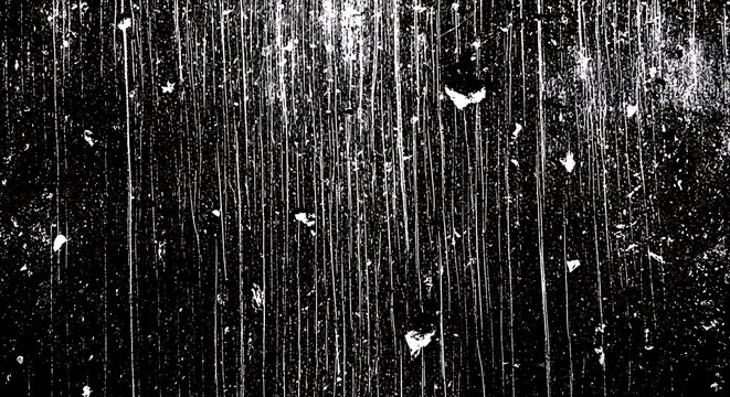 Abstract black and white texture with vertical streaks and scattered specks, resembling rain on glass or a scratched surface.