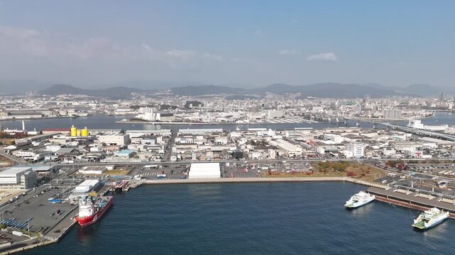 Hiroshima Port, Japan: 4K Aerial Drone Footage of Ferry Terminal, City Skyline, Hiroshima Bay, Harbour Infrastructure, Coastal Mountains and Waterfront Urban Landscape, Ujina Island and Kanawa Island