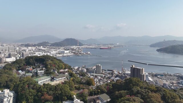 Hiroshima Port, Japan: 4K Aerial Drone Footage of Ferry Terminal, City Skyline, Hiroshima Bay, Harbour Infrastructure, Coastal Mountains and Waterfront Urban Landscape, Ujina Island and Kanawa Island