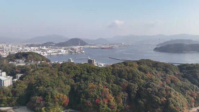 Hiroshima Port, Japan: 4K Aerial Drone Footage of Ferry Terminal, City Skyline, Hiroshima Bay, Harbour Infrastructure, Coastal Mountains and Waterfront Urban Landscape, Ujina Island and Kanawa Island
