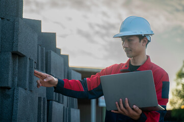 A quality assurance staff member flagging a specific section of the block inventory for detailed testing, recorded digitally on a laptop.