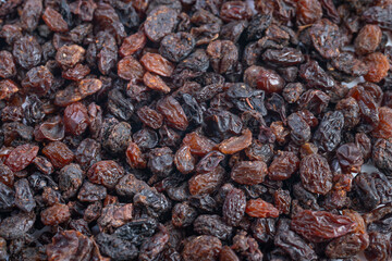 Basket of Wrinkled Brown Raisins with Sugar Crystals, Detailed Closeup of Piled Dark Raisins Enhanced by Glossy Surface and Subtle Sugar Crystals for Culinary Photography