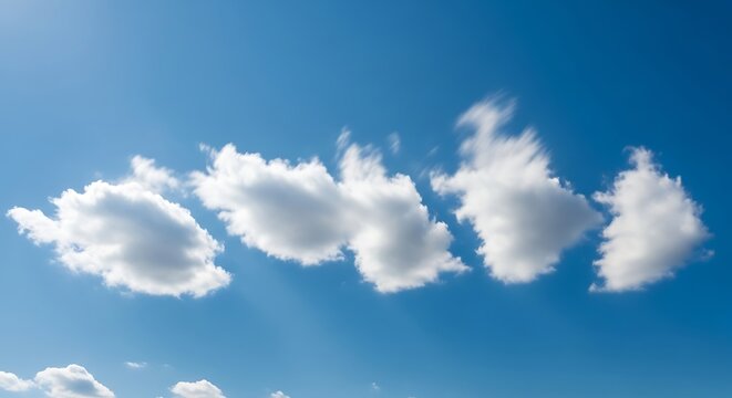 A vibrant blue sky adorned with fluffy, white clouds stretching across the frame, kissed by the sun's rays - Powered by Adobe