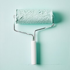Obraz premium Paint roller on mint green wall