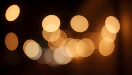 Blurred golden lights softly glow against a dark background.