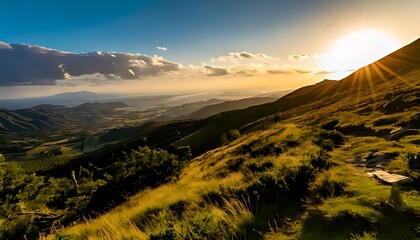 A breathtaking landscape bathed in golden sunlight. The scene depicts rolling hills and distant mountains under a radiant sky