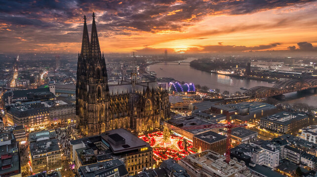 Aerial view of the Cologne Cathedral Christmas Market (Weihnachtsmarkt am K&ouml;lner Dom) on Roncalliplatz at sunset - Holiday celebrations in Germany