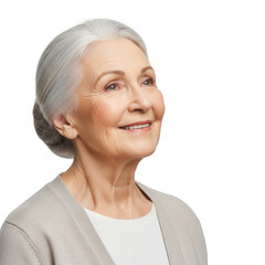 Smiling senior woman with gray hair and beige cardigan looking up with a gentle expression on black background.