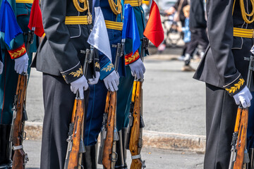 Soldiers of the honor guard with weapons on the street.