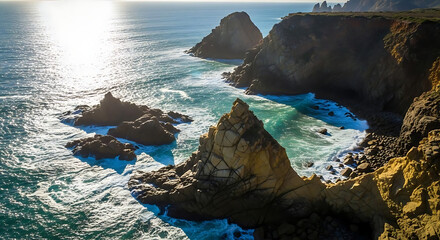 Dramatic rugged rocky coastline with ocean waves crashing against cliffs and shoreline in natural scenic landscape during daytime with sunlight