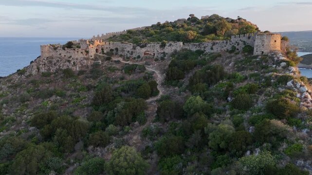 Pylos,Messinia,Peloponnese,Aerial view backwards than circle pan left around Navarino Castle during sunrise.Colorful clouds and sky.
