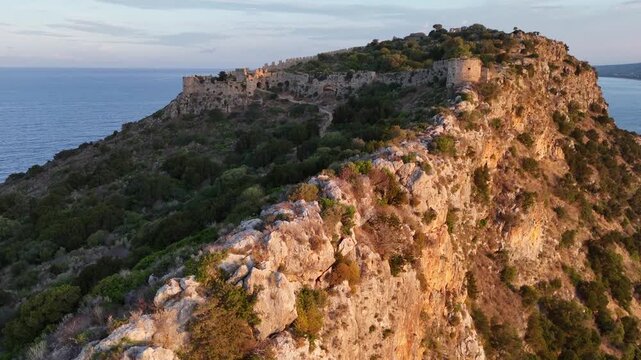 Pylos,Messinia,Peloponnese,Aerial view forward towards Navarino Castle ruins on the top of the hill during sunrise.Colorful clouds and sky.