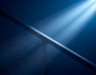 Beam of light illuminates a diagonal metallic structure against dark blue