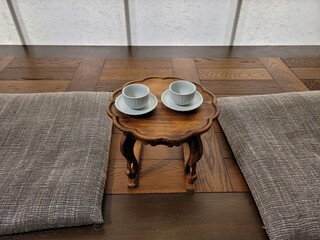 Traditional Korean Seating Area with Low Wooden Table and Tea Cups