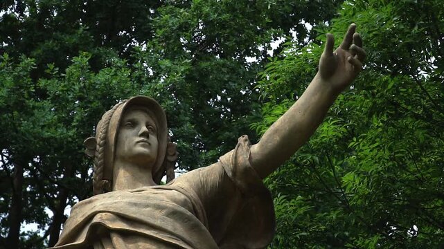 Close up of Vysehrad stone statue in Prague park with dramatic gesture