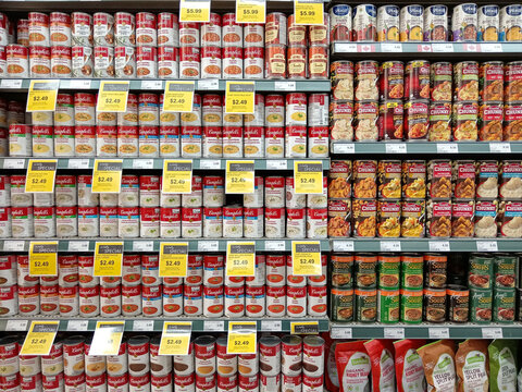 British Columbia, Canada - September 12, 2025: Shelves filled with different types of canned soup are shown in a supermarket in a grocery store food aisle. Sale prices are marked prominently.