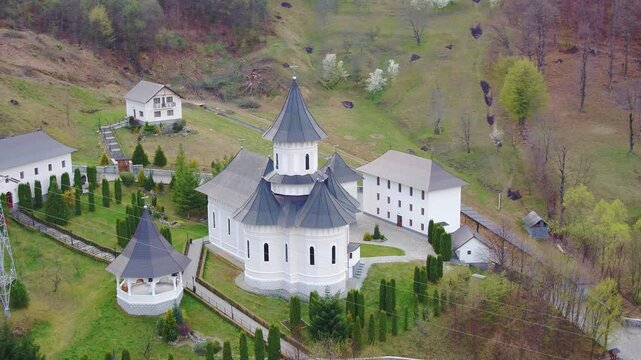 Aerial Shot of Orthodox Monastery Church Complex in a Green Mountain Valley. Rebra - Parva, Romania