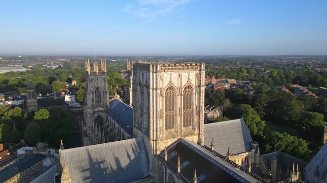 Aerial drone point of interest shot rotating clockwise around the central tower of York Minster, showcasing the Gothic cathedral&rsquo;s architecture from above in York, England.