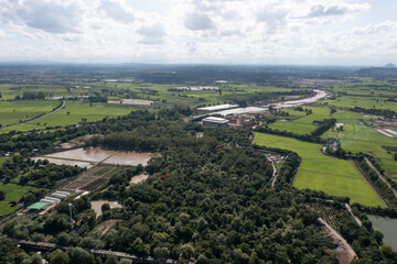 Obraz premium Top view of the Sakae Krang River, Uthai Thani Province where both sides of river are filled with lush green trees. There are community near waterside.