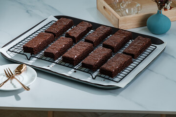many chocolate brownies in baking tray on white table