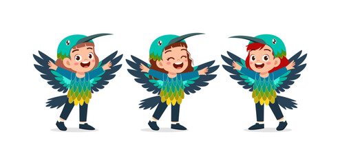Three happy Asian children playing joyfully in colorful bird costumes with big smiles