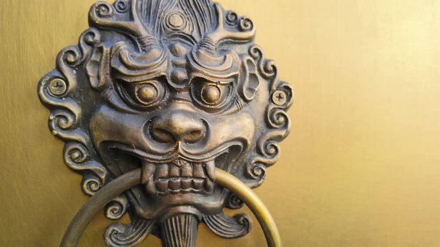 Close up of Chinese style bronze lion door rings