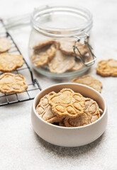 Homemade dog treats in paw print shape cooling and stored