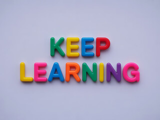 Motivational phrase "keep learning" spelled out using vibrant, multicolored alphabet letters