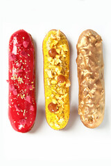 Glazed eclairs on a white background. A set of eclairs on a white background. French classic dessert. Top view. Isolated object.