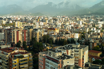 the view over rooftops from the centre of tirane with mountains in the background